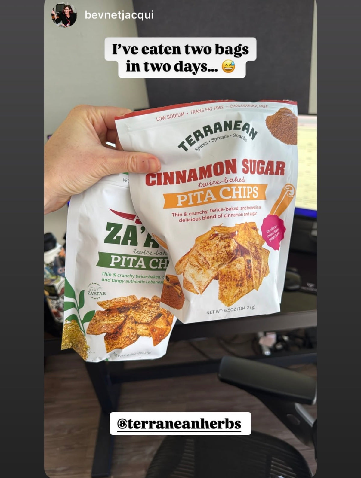 hand carrying two pita chip bags 